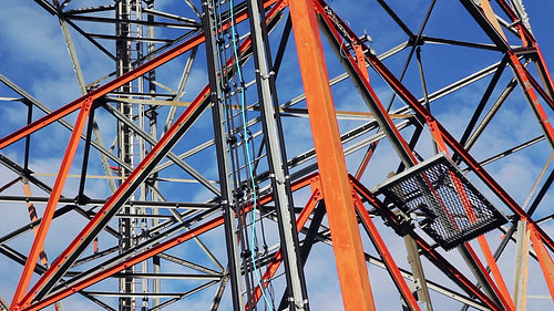 Red and white communication tower. Frame section. Time lapse. HD.
