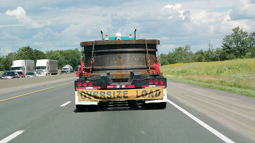 Oversize load. Following truck on the highway. HD.