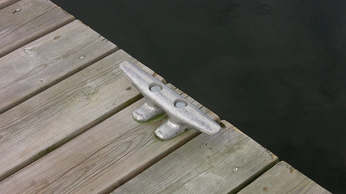 Cleat on wooden deck with water. Top down, diagonal view. HDV footage. HD.