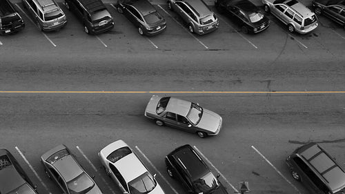 Car finds parking spot. Black and white with yellow line. HD.