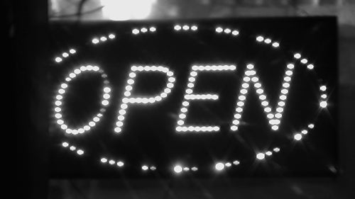 Open sign with flashing LED lights. Shop advertising. Toronto, Canada. Black & white. HD video.