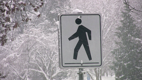 Pedestrian sign during snowstorm. Vancouver, BC, Canada. HD video.