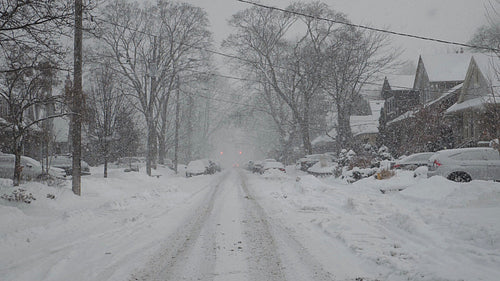 Slow motion snow falling on suburban street. Winter in Toronto, Canada. HD