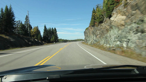 Sunny drive in Northern Ontario. Rockcut on right. Barrier on left. HD.