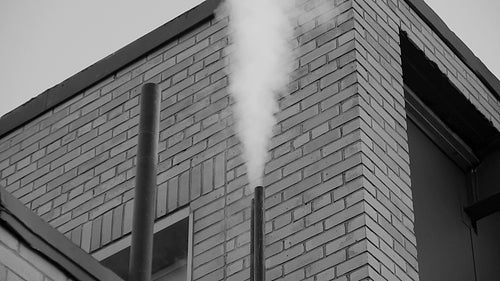Factory steam. High pressure steam coming out of industrial pipe. Black & white. HD video.