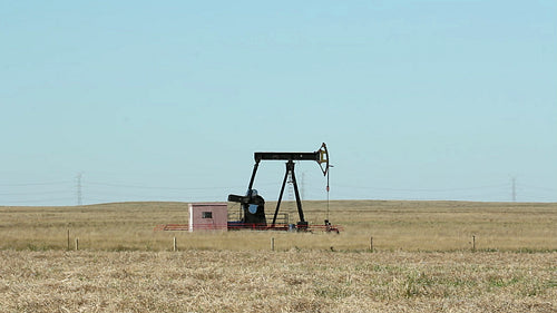 Pumpjack on the prairie. Alberta, Canada. HD.