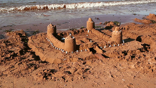 Sand castle on the beach. Red sand. PEI, Canada. HD.