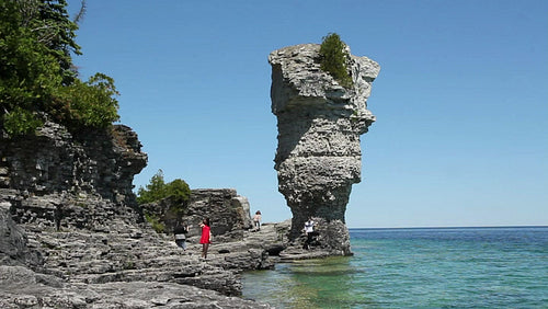 Tourists and flowerpot rock formation in Tobermory, Ontario, Canada. HD.
