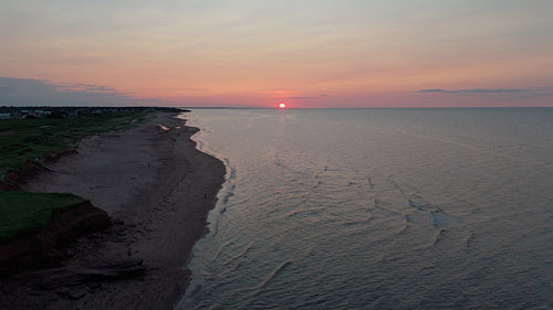 Sunset drone flight rising over seashore. PEI, Canada. 4K.