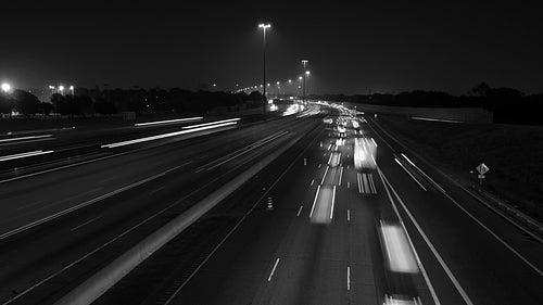 Highway 401 in Toronto. Time lapse of lanes at night. Fast & slow lanes. Black & white. HD video.
