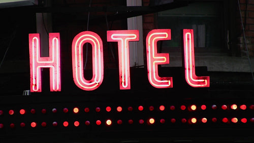 Old hotel sign. Red neon with blinking lights. Toronto, Canada. HD video.