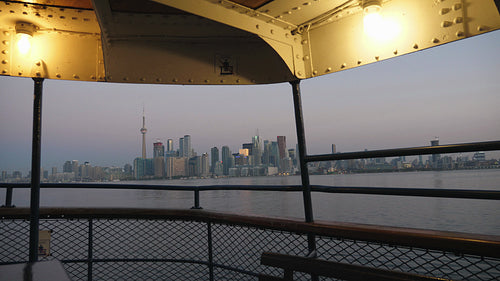 Dawn view of Toronto skyline as ferry pulls into Ward's island. Summer. 4K stock video.