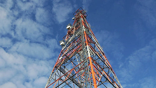 Red and white communication tower. Low angle. Timelapse. HD.