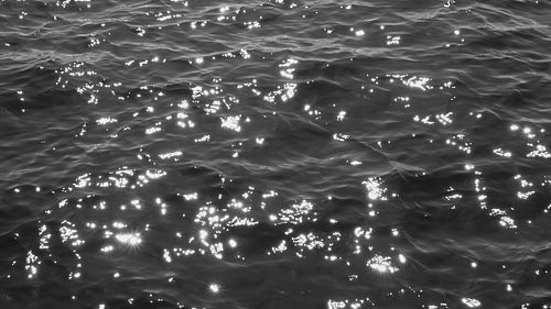 Slow motion B&W lake water with sun reflections. Lake Ontario, Canada. HD stock video.