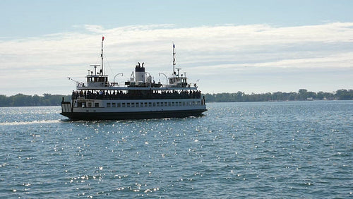 Slow motion view of public ferry leaving Toronto for the Toronto islands. HD stock video.