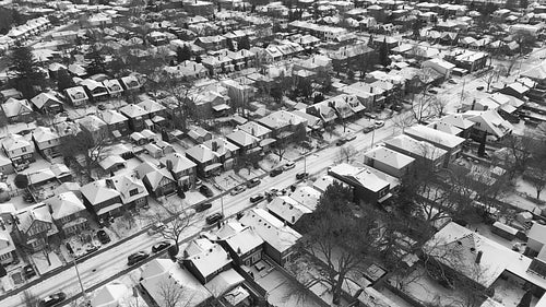 Snowy suburban neighbourhood. Black and white. Advancing drone shot. East York, Toronto. 4K.