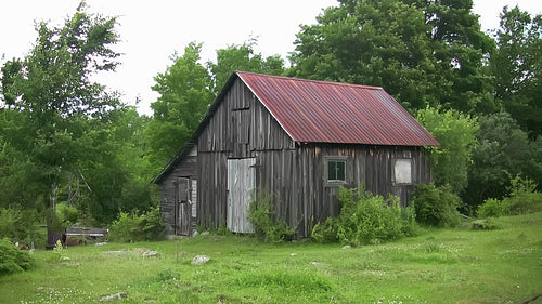 Wooden shed with tin roof in rural Ontario. Wide. HD.