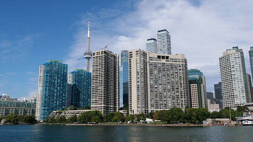 View of watefront condominiums and CN tower taken from ferry. Toronto. HD stock video.