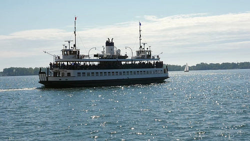 Slow motion view of public ferry leaving Toronto for the Toronto islands. HD stock video.