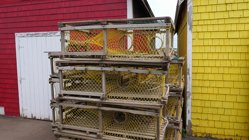 Tilt up to stack of lobster traps. Prince Edward Island, Canada. 4K.