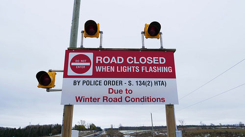 Road closed when lights flashing. Sign to warn drivers of Winter road closure. 4K.