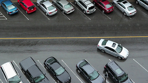 Car finds parking spot in the rain. HD.