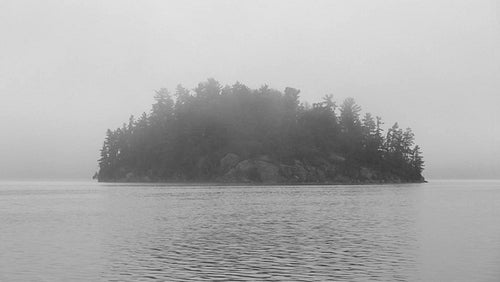 Mysterious, misty island. Black and white. Muskoka, Ontario, Canada. HDV footage. HD.