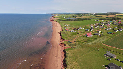 Drone aerial flight descent to beach front community. Summer in PEI, Canada. 4K.