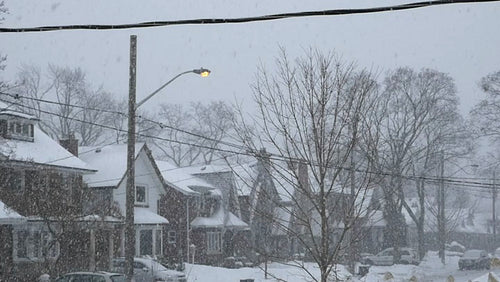 Slow motion snow falling in the street. Toronto, Canada. HD.