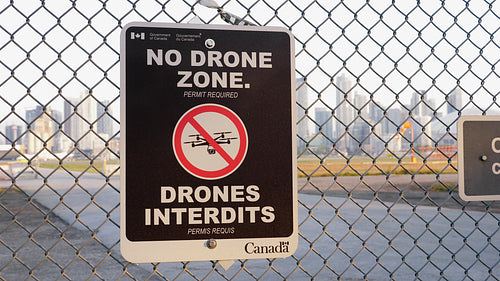 No Drone Zone sign at fence outside Toronto Island Airport. 4K stock video.