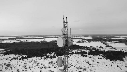 Drone shot of communications tower antenna. Black and white. Winter in Ontario, Canada. 4K.