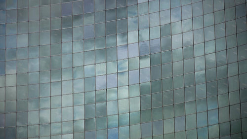 Time lapse clouds reflected in curved windows of office. Toronto. HD video.