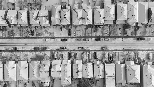 Snowy suburban neighbourhood in black and white. Rising drone birdseye shot. East York, Toronto. 4K.