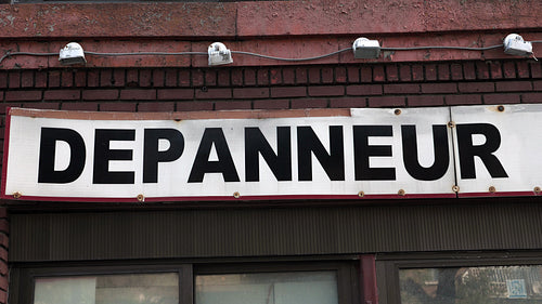 Depanneur store in Montreal, Quebec, Canada. Tilt down to sign. 4K.