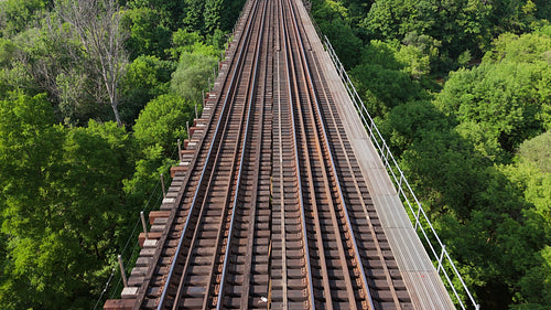 Drone following train tracks on top of trestle bridge. Toronto. 4K.