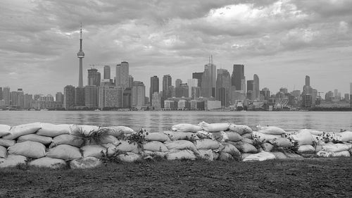 Sandbags on Toronto island from summer flooding of Lake Ontario. Black & white. 4K stock video.