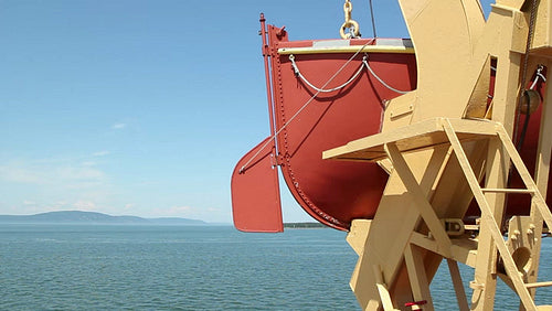 Orange lifeboat detail. Ferry crossing the St. Lawrence river. HD.