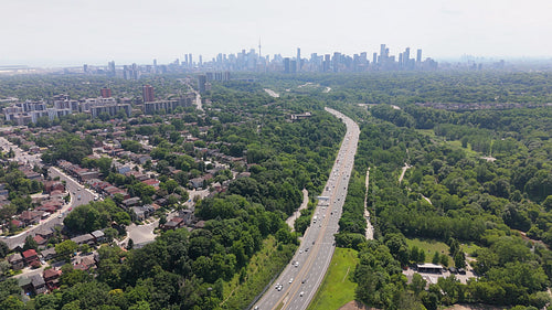 Drone aerial view of Don Valley Parkway with Toronto in the distance. 4K.