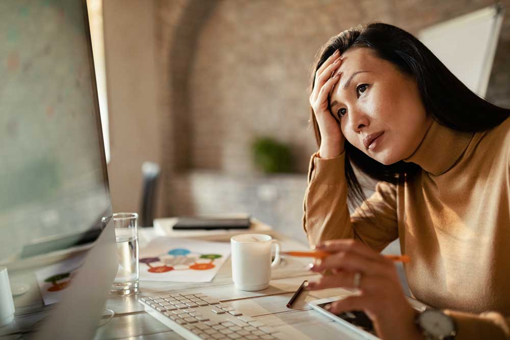 Photograph of stressed asian woman struggling to find good stock footage