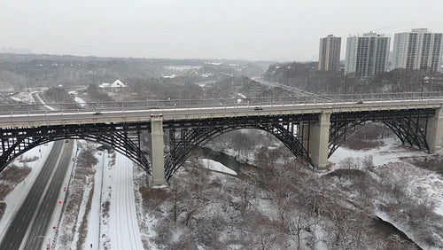 Drone aerial. Bloor Viaduct with train. Winter in Toronto. 4K. Editorial Use Only.