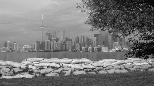 Sandbags on Toronto island from summer flooding of Lake Ontario. Black & white. 4K stock video.