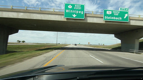 Manitoba bridges with signs for Winnipeg and Steinback. HD.