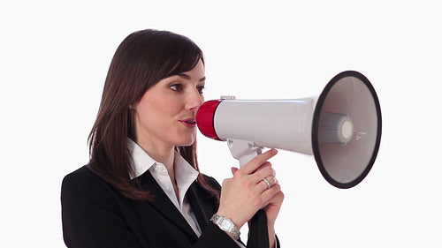 Female executive holds up megaphone and starts talking. Three quarter view. HD.