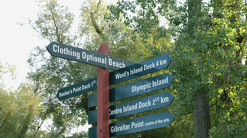 Toronto Islands sign including directions to clothing optional nude beach. 4K stock video.