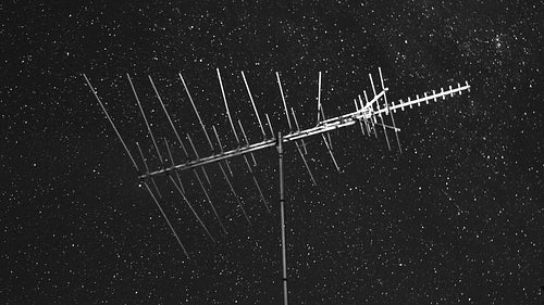 Vintage TV antenna with night sky stars time lapse. Black and white. HD video.