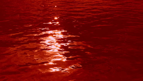 Blood lake. Slow motion ominous and spooky lake tinted blood red. HD.