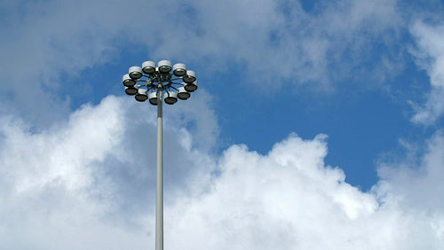 Highway electrical light lampost with white clouds and blue sky. 4K.