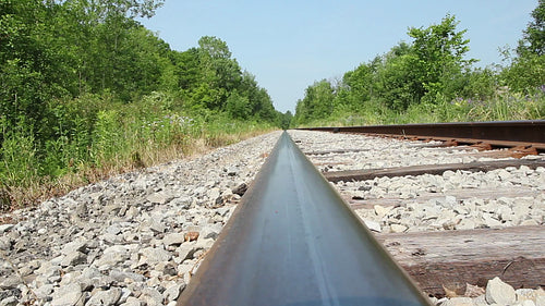 Train rail viewpoint. Train tracks in the countryside. Summer in Ontario, Canada. HD video.