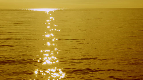 Slow motion lake with brilliant sun reflections. Lake Ontario. Golden tint. HD stock video.
