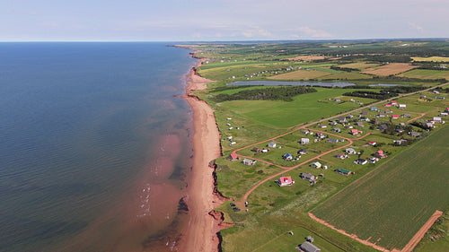 Drone aerial flight over beach front community. Summer in PEI, Canada. 4K.